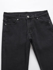 Black wash jeans with split hem detail and classic five-pocket styling.