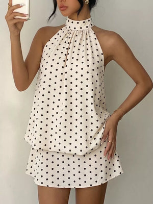 Chic polka dot halter mini dress in apricot with a gathered neckline and A-line skirt.