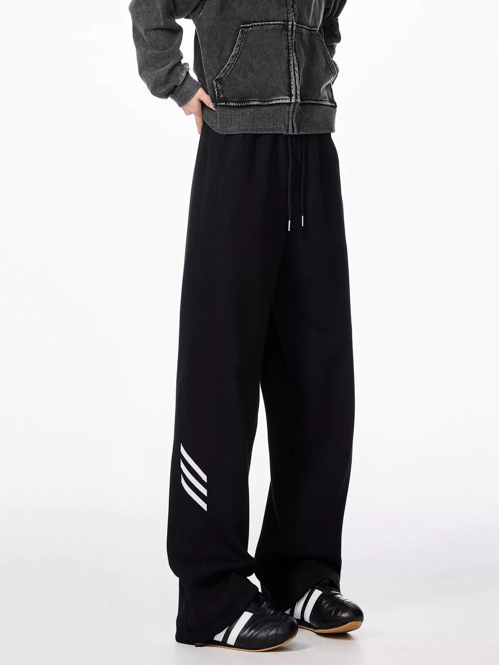 Black relaxed fit sweatpants with drawstring and white stripe detail on leg