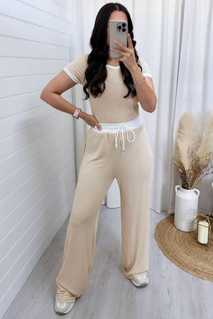 Tan ribbed loungewear set with contrast trim on the top and drawstring waist pants.