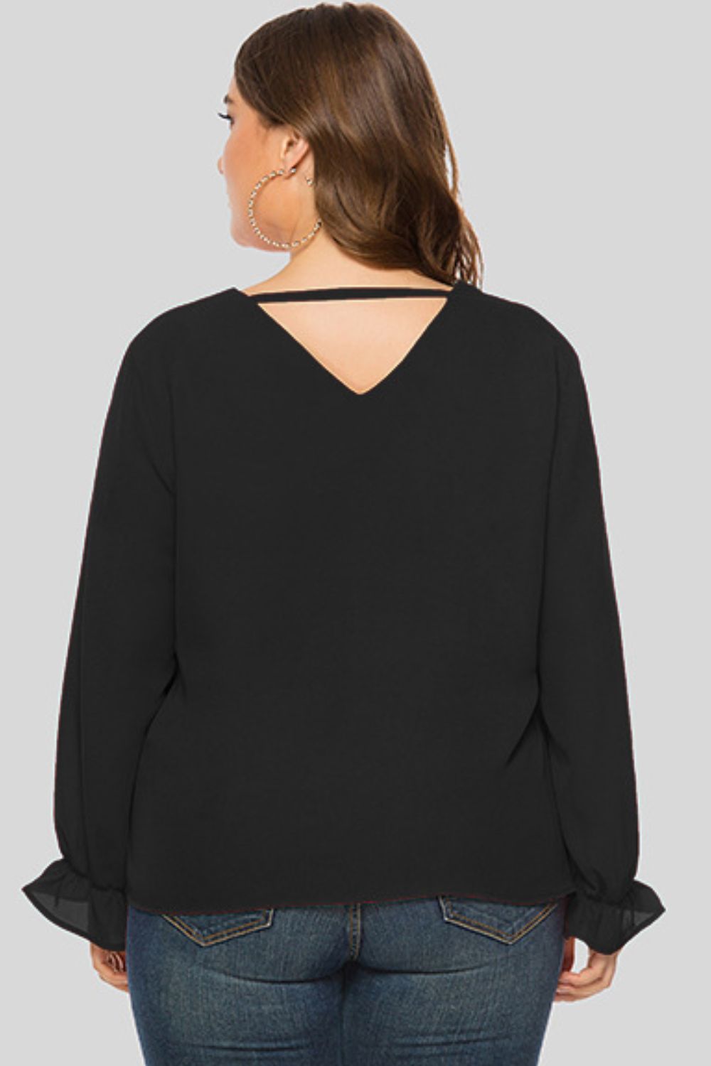 Black V-neck blouse with long sleeves and cutout detail at back neckline.