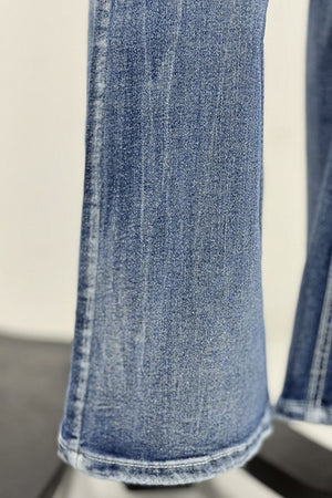 Light wash bootcut jeans with subtle whiskering and contrast stitching.