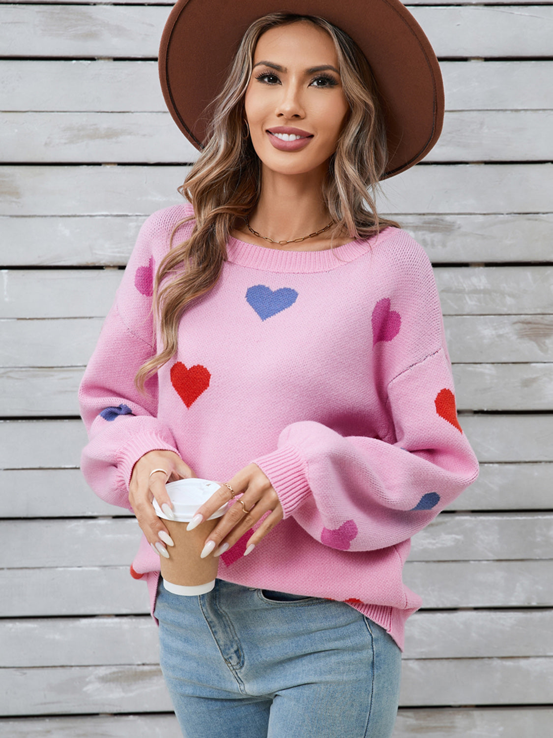 Pink acrylic knit sweater with heart motif and bubble sleeves