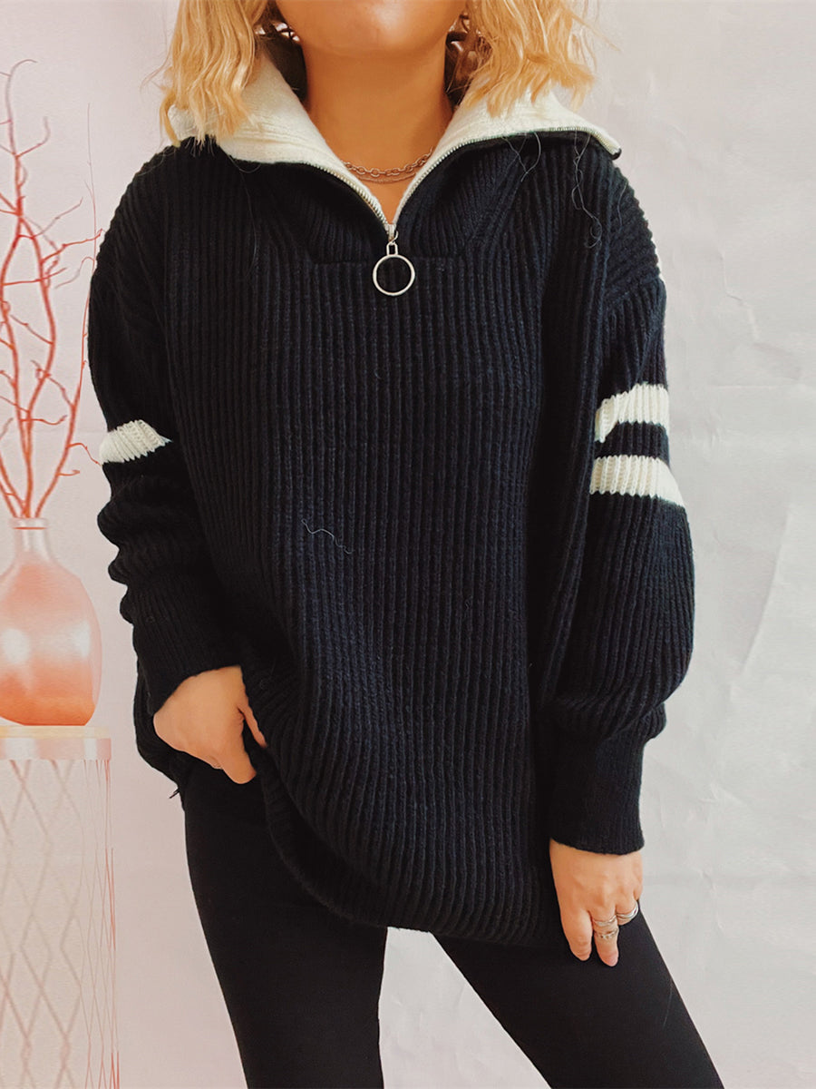 Black acrylic sweater with white varsity stripes on sleeves and ribbed collar.