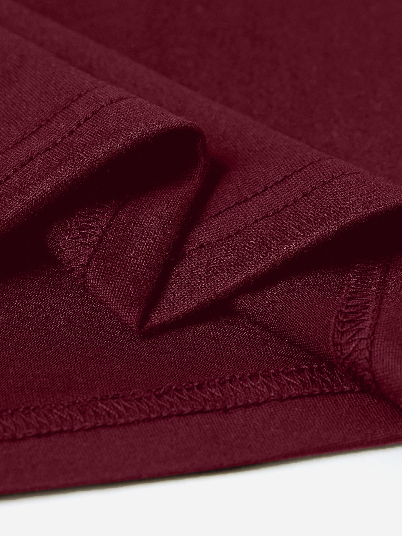 Burgundy maternity t-shirt detail showing hem and stitching.
