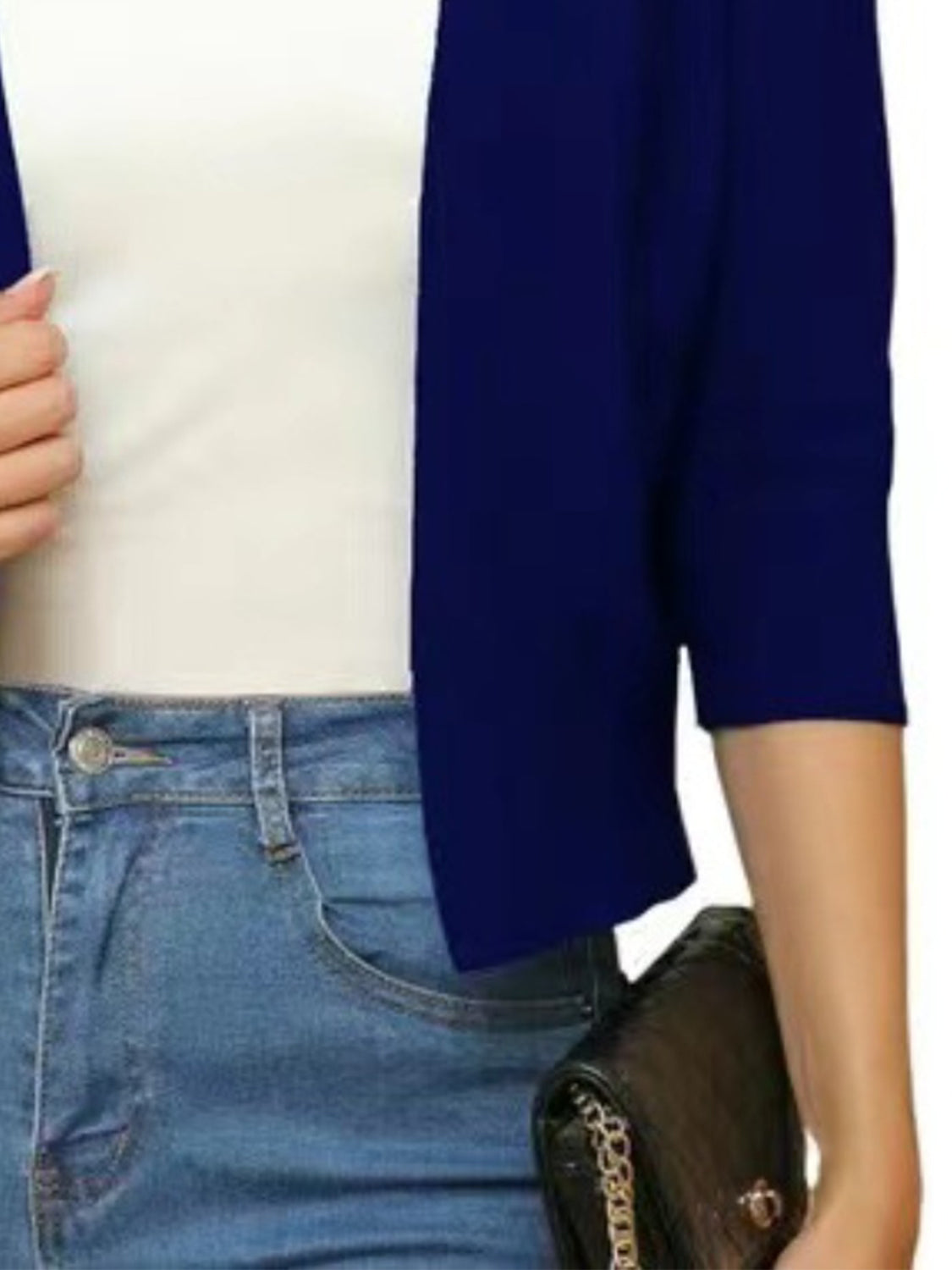 Navy open-front cropped cardigan with elbow sleeves worn over a white top and jeans.