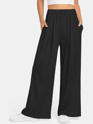 Black pleated palazzo trousers with pockets and elastic waist.