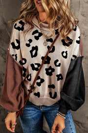 Colorblock leopard print knit sweater with contrast sleeves and crew neck.