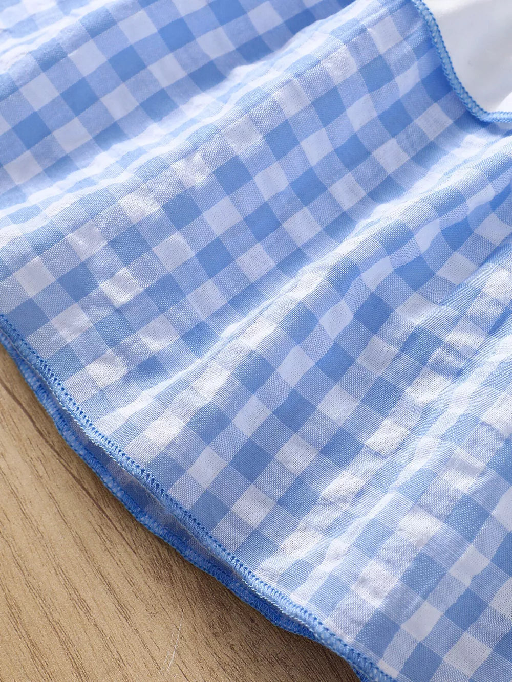Blue gingham cotton cami and shorts set with ruffled trim.