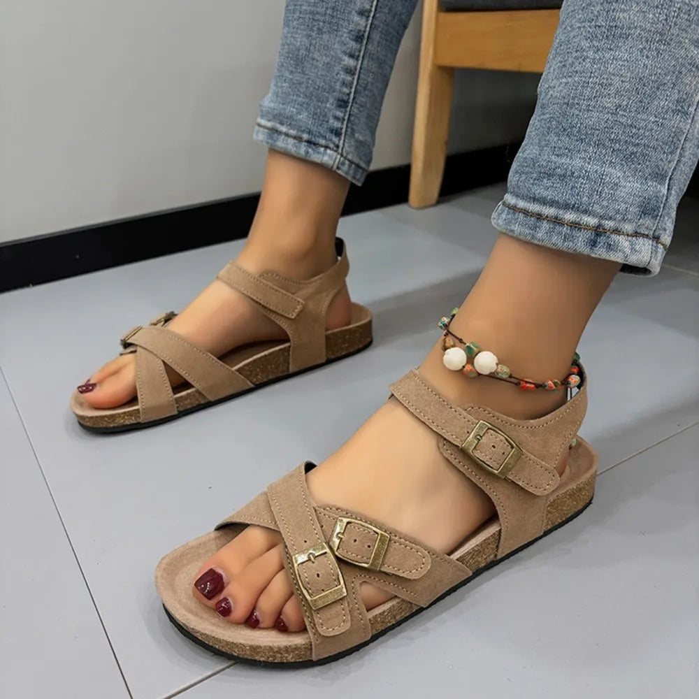 Khaki suede crossover buckle cork sandals with adjustable straps.