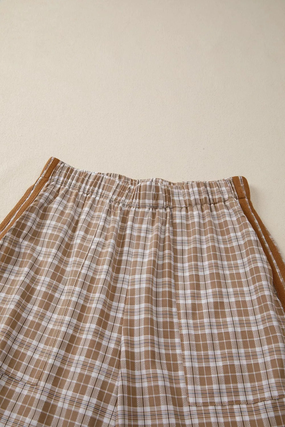 Plaid print casual pants in camel with drawstring waist and side stripe detail.