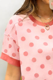 Pink polka dot short sleeve t-shirt with crew neck and contrast trim.