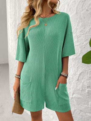 Green ribbed knit romper with short sleeves, crew neck, and front pockets.