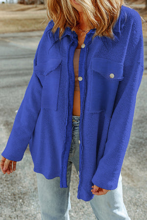 Royal blue textured shacket with raw-edge detailing and buttoned pockets.