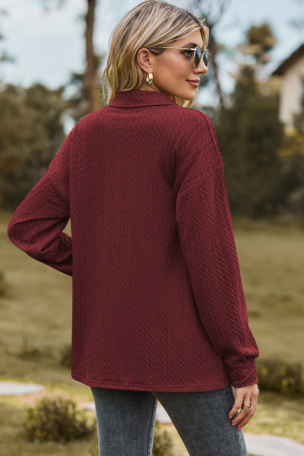 Burgundy textured polo-neck sweater with button detail and long sleeves.
