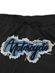 Black sweatpants with drawstring and embroidered motorcycle graphic patch.