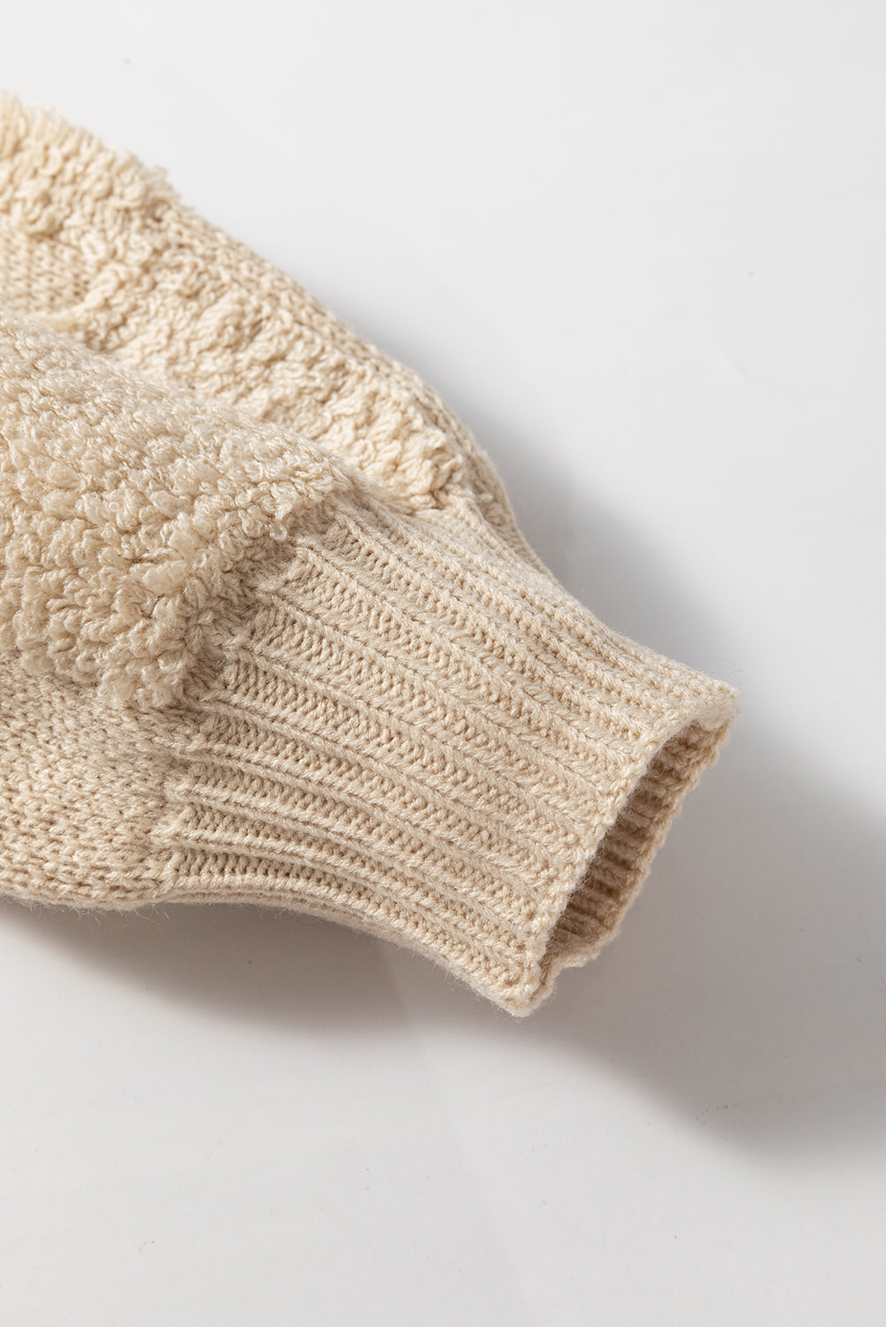 Beige acrylic knit sweater with textured checkerboard pattern and ribbed cuffs.