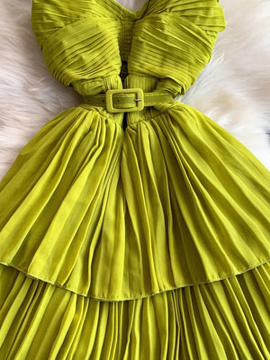 Yellow belted midi dress with spaghetti straps and pleated details.