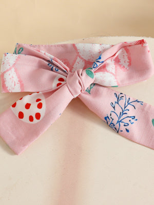 Pink baby headband with bow detail and Easter egg print