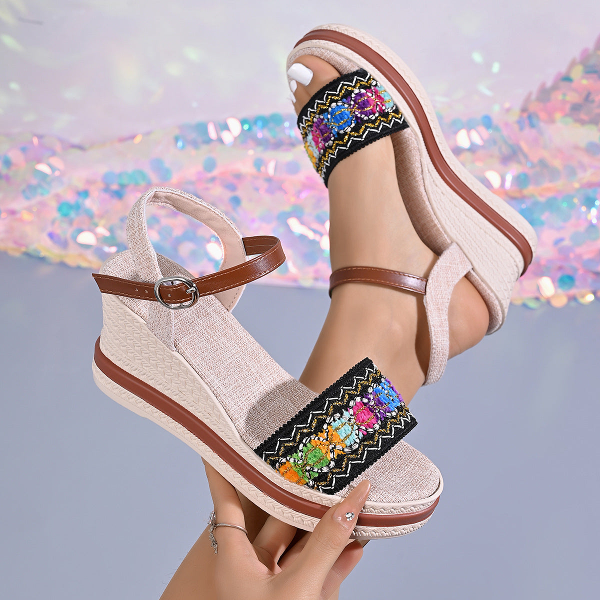 Embroidered floral wedge sandals in beige with adjustable ankle strap and brown trim.