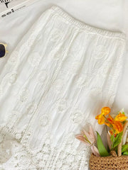 White lace midi skirt with elastic waist and crochet details.