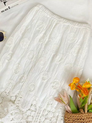 White lace midi skirt with elastic waist and crochet details.