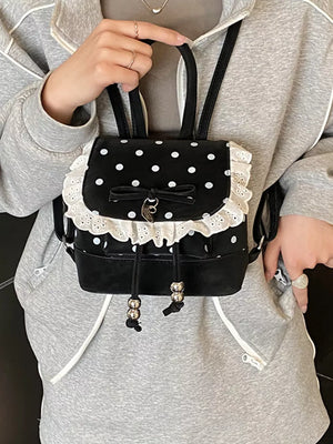 Black polka dot mini backpack with white lace trim and bow detail