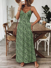 Matcha green wide-leg jumpsuit with black abstract print, spaghetti straps, and V-neck.