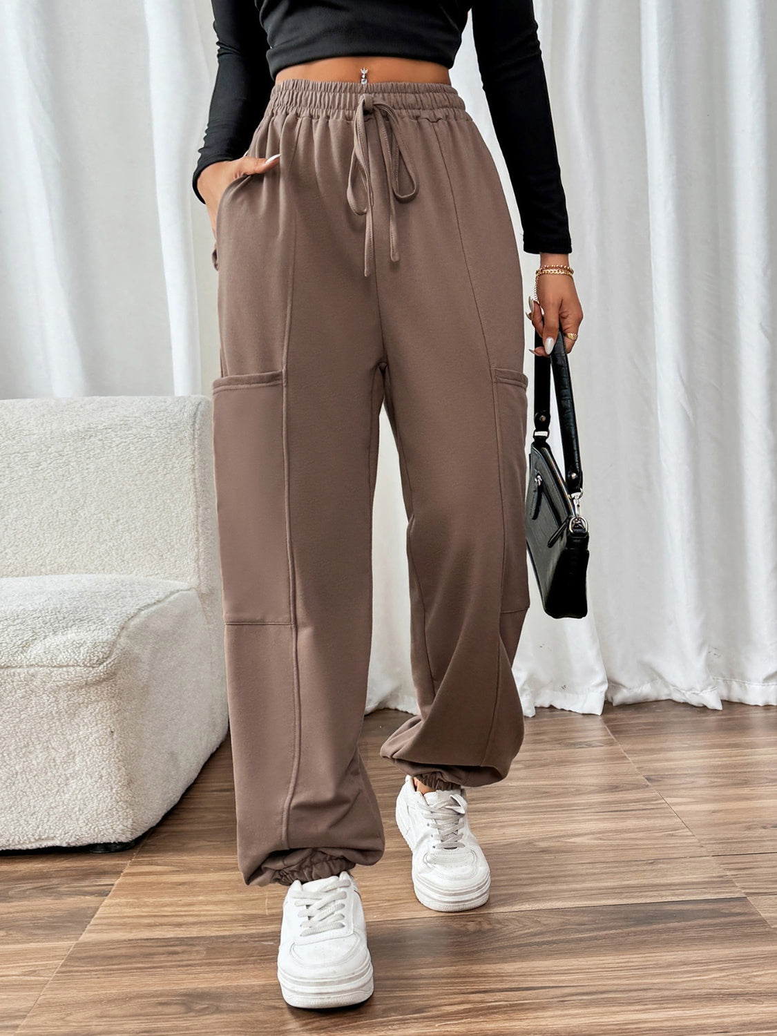 Taupe cargo joggers with drawstring waist and elastic cuffs.