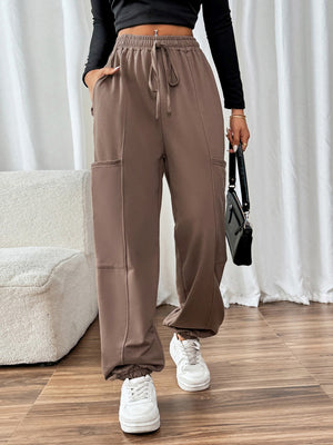 Taupe cargo joggers with drawstring waist and elastic cuffs.