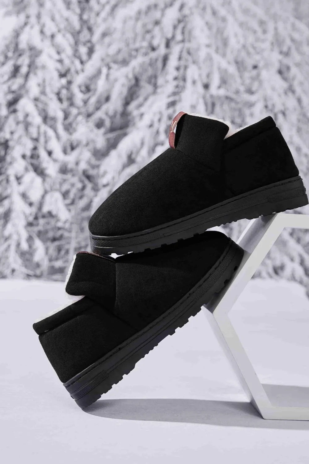 Black suede shearling-lined house booties with a pull tab detail.