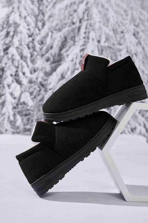 Black suede shearling-lined house booties with a pull tab detail.