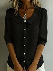 Black button-down shirt with puff sleeves and Peter Pan collar