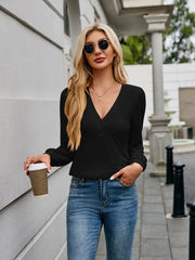 Black plunge neck gathered sleeve top with textured detail