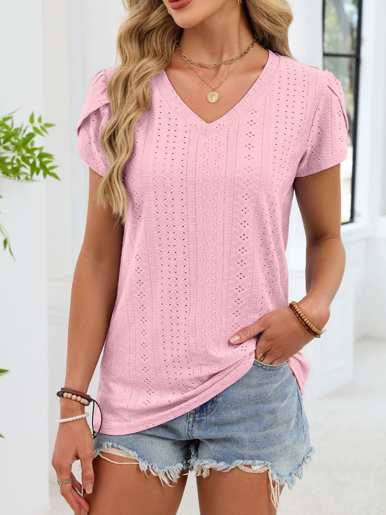 Blush pink eyelet tee with petal sleeves and V-neck.