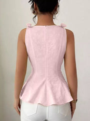 Pink peplum tank top with floral embroidery and bow shoulder details