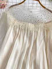 Apricot sheer mesh blouse with rhinestone-embellished neckline and feather trim.