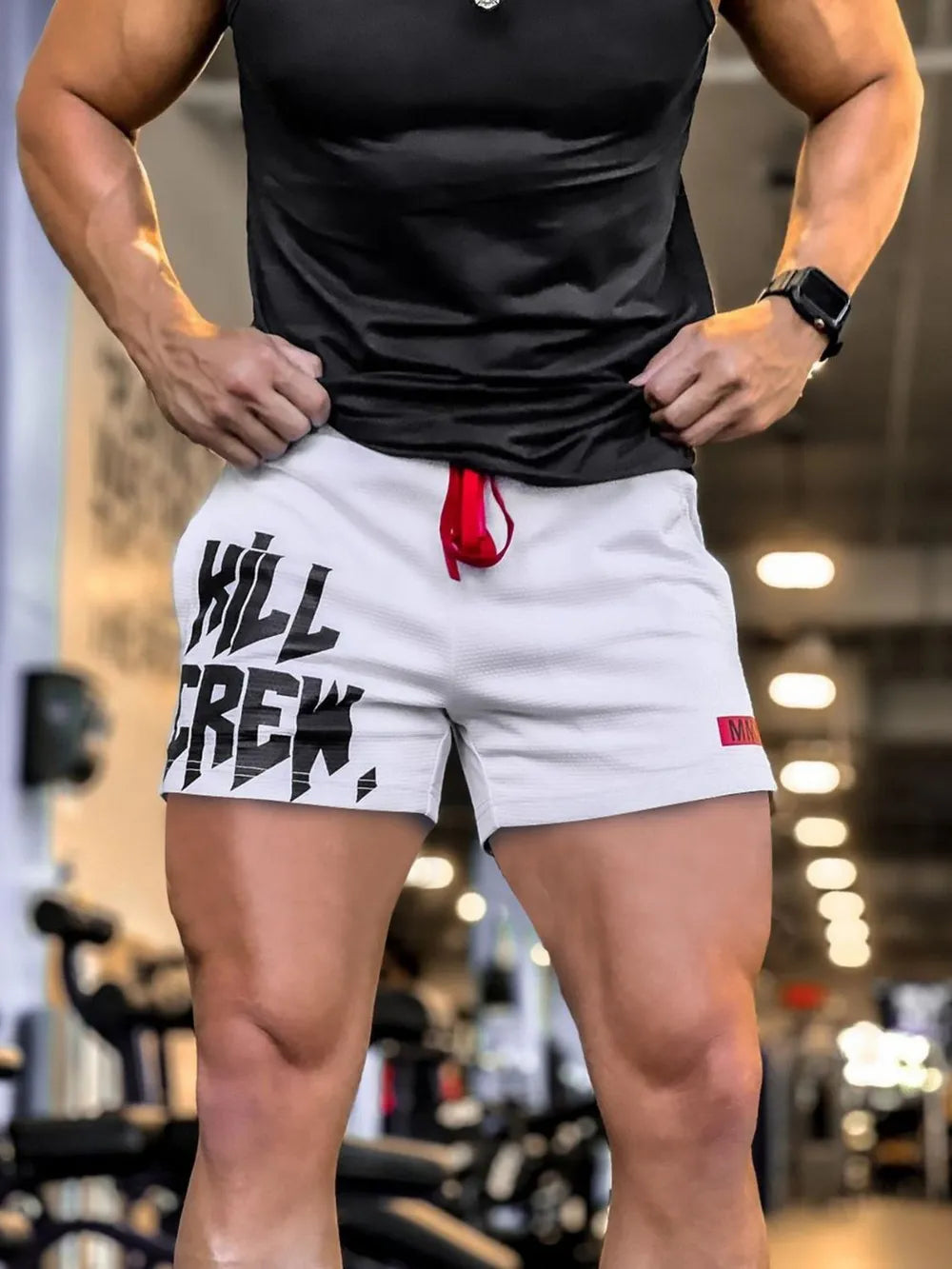 White graphic performance shorts with red drawstring and textured fabric.