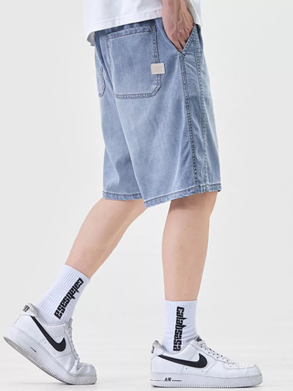 Light blue denim shorts for men, loose fit, casual style, with back pockets.
