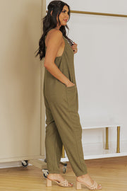 Relaxed-fit olive green jersey jumpsuit with slouch pockets and a V-neck.