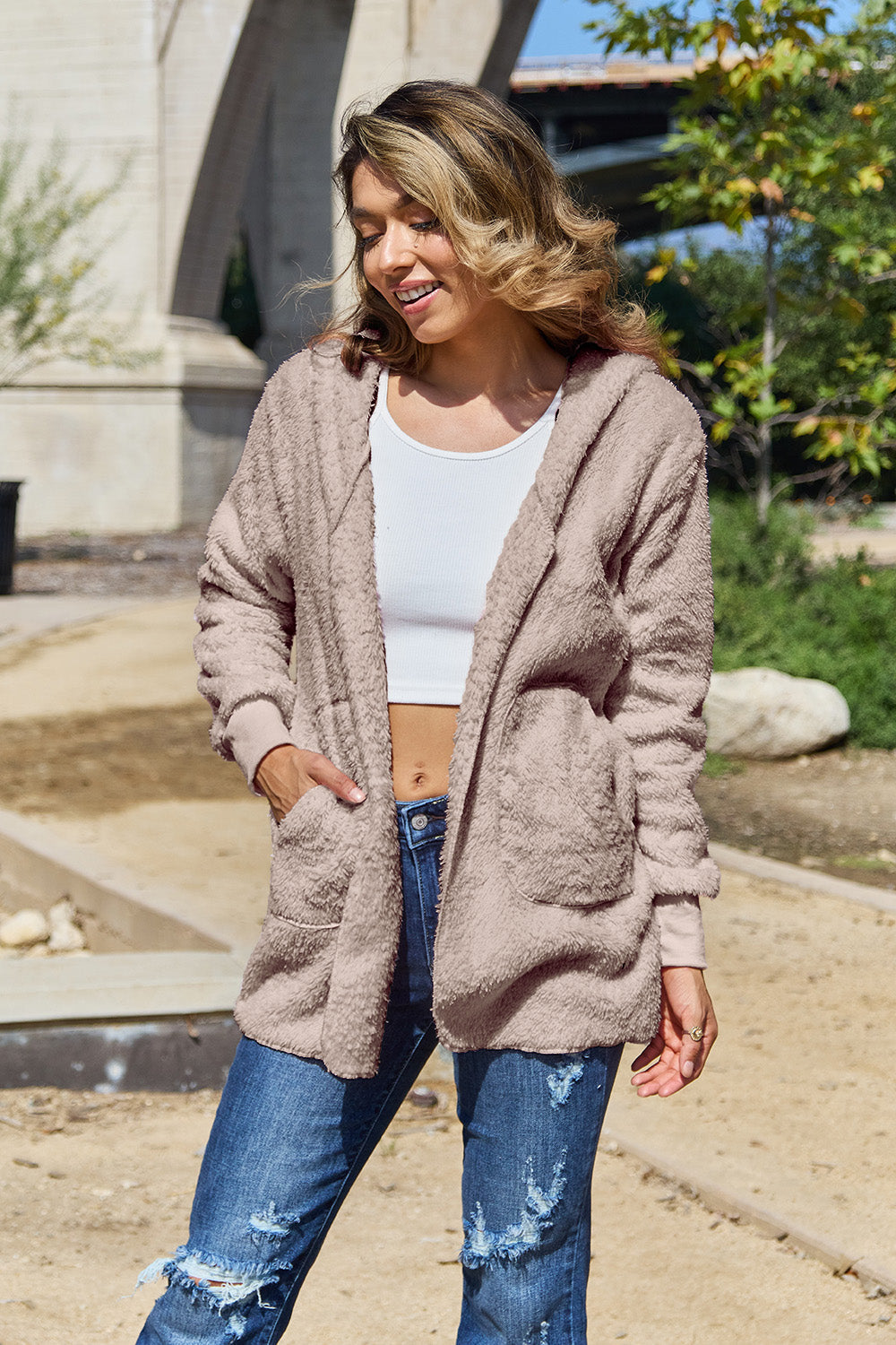 Plush hooded cardigan jacket in blush pink with open front and pockets.