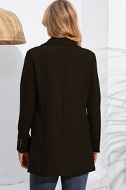 Black double-breasted tailored blazer with flap pockets and button cuff detail.