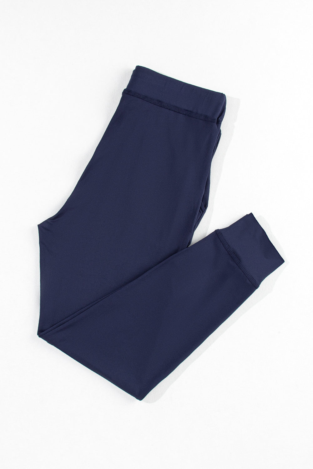 Slim-fit navy lounge trousers with elastic waistband and cuffed ankles.