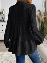 Black textured tiered button-down shirt with crinkled fabric and long sleeves.