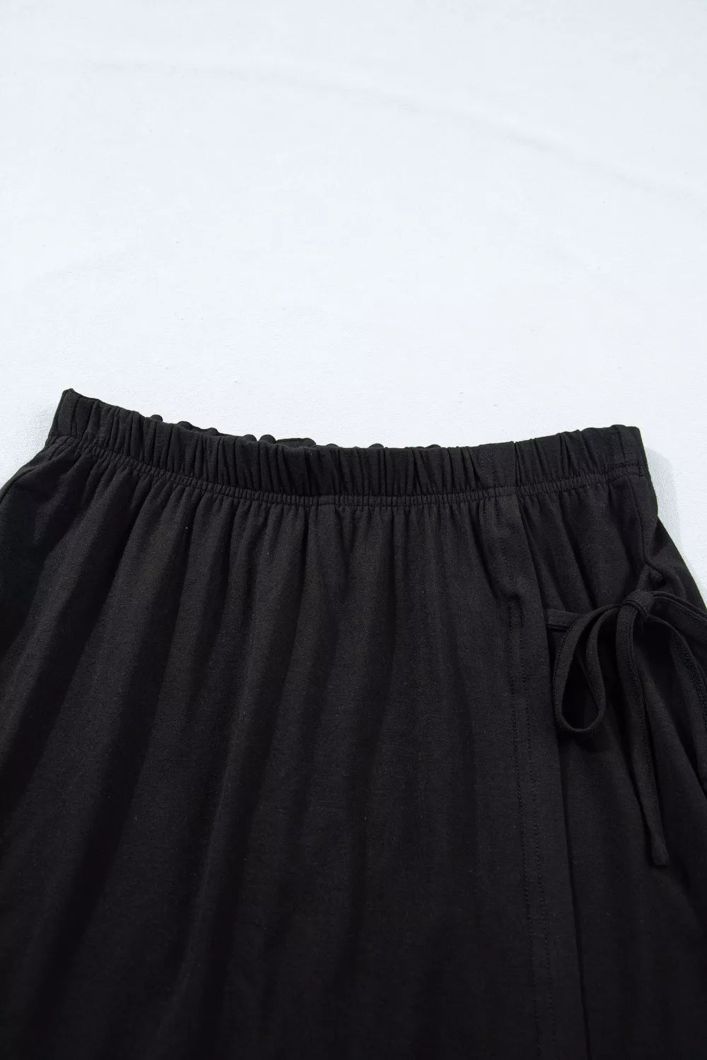 Black tie-wrap two-piece ensemble with elastic waistband and drawstring detail