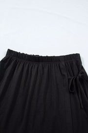 Black tie-wrap two-piece ensemble with elastic waistband and drawstring detail