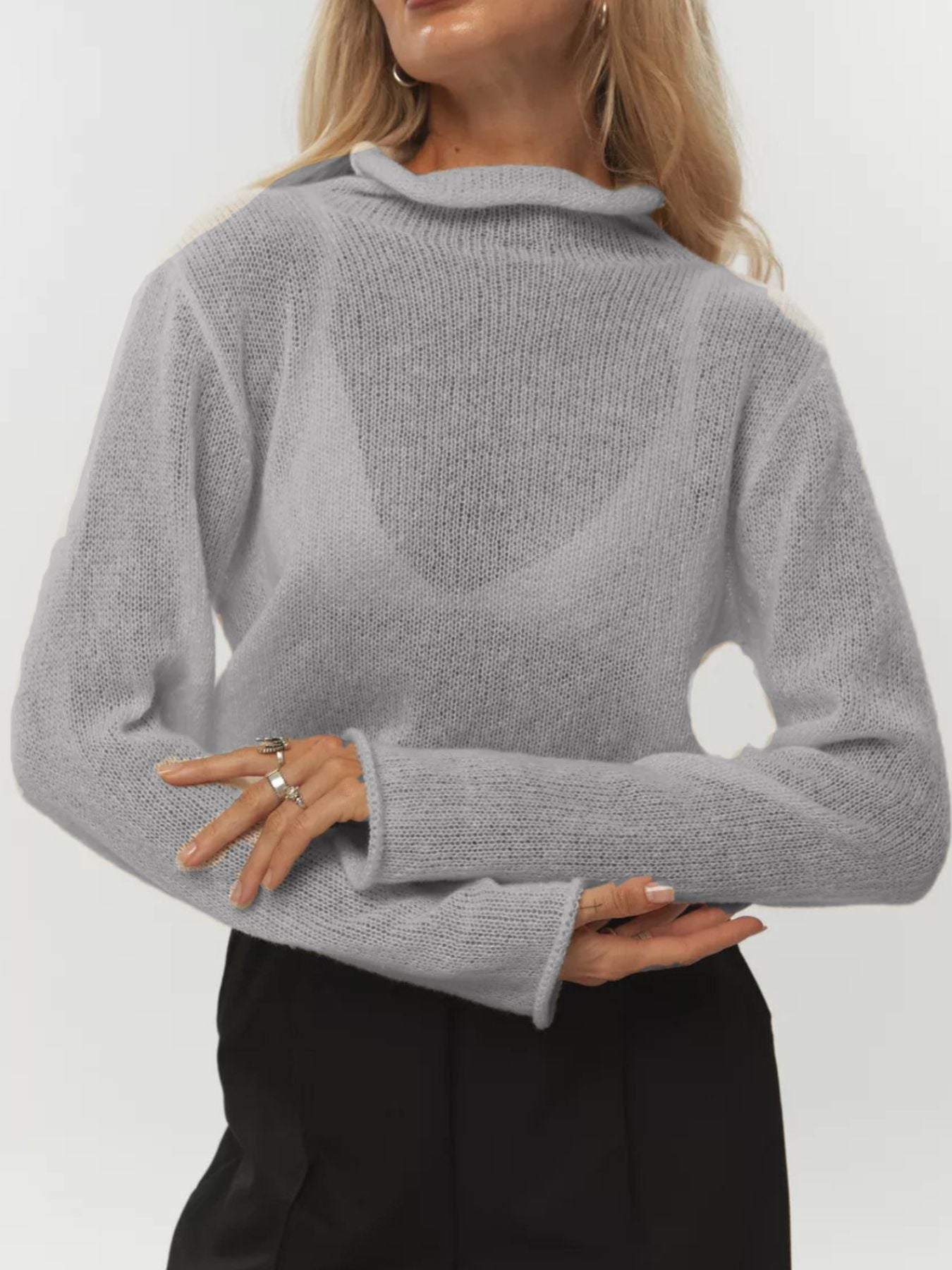 Sheer mock neck knit sweater in light gray with a draped neckline and long sleeves.