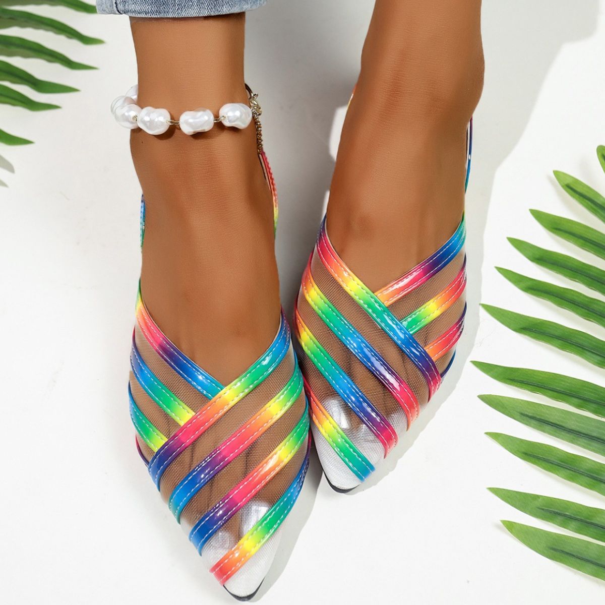 Chic mesh pointed slingback sandals with rainbow straps and a pearl anklet.