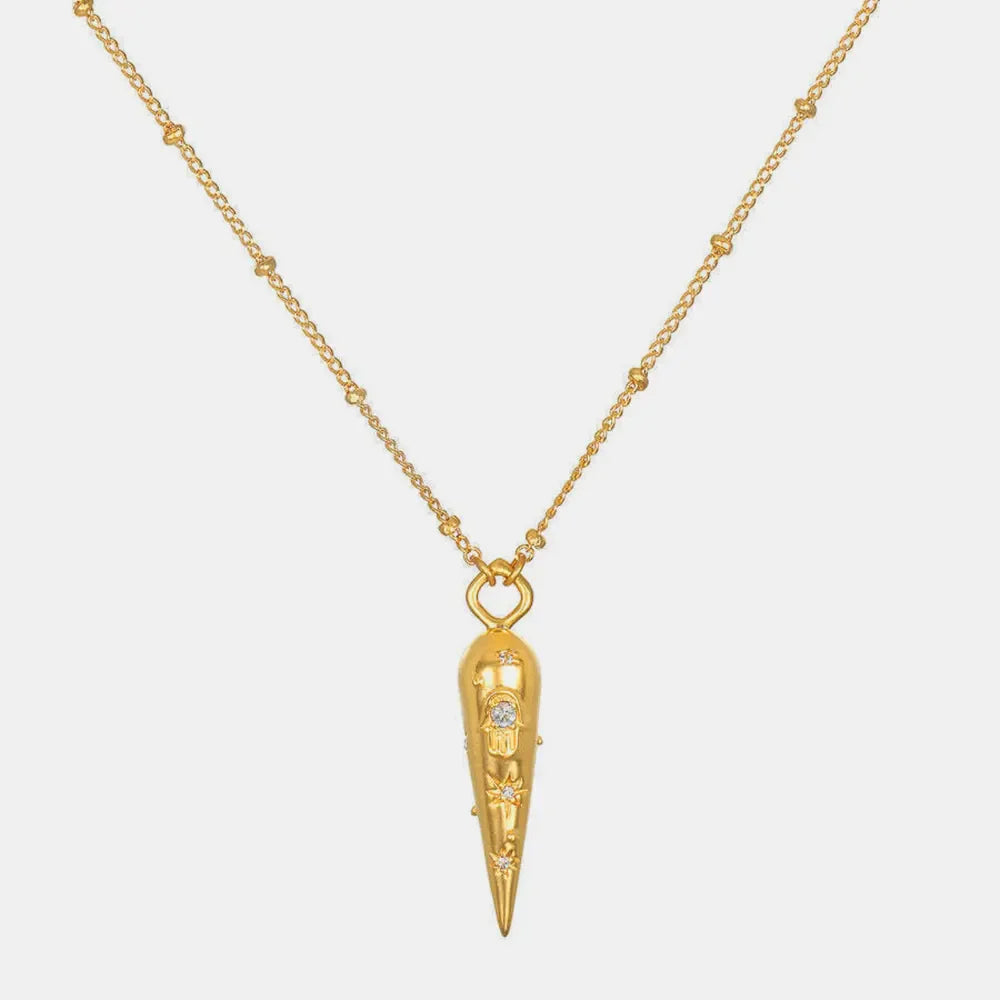 Gold layered necklace with beaded chain and conical pendant featuring celestial charms.
