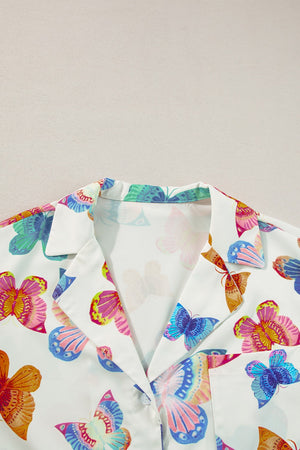 White pajama set with colorful butterfly print, featuring a classic collar and button-up detail.